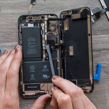Battery being removed from an opened iPhone